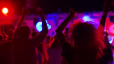 2020-07-25 - Henychensk, Ukraine. Spot Guide Kite Club - Wave Festival. Multi ethnic people in boho outfits dance enjoy open air music fest by a sea. Stylish audience have fun on beach party at night.