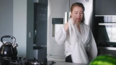 Economical inflation. Young girl standing shocks after seeing long shopping bill list. Girl looking at long paper receipt shocked after counting expenses. Price check in stylish modern kitchen