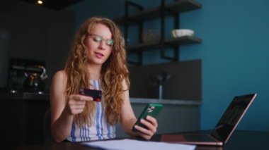 Mutlu kadın satın alıyor, Fintech uygulaması ile ödeme yapıyor. Alışveriş yapan kız mobil bankacılık uygulaması kullanıyor. İnternet mağazasındaki ürünleri ödemek için kredi kartı kullanıyor. Düzenin sağlanması için kadın alkışı..