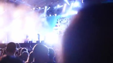 2019-08-09 - Mariupol, Ukraine. MFest festival. Woman sits on boyfriend shoulders, dance waving hands at music concert on open air fest. Crowd jump, applause, enjoy favourite band performance on stage