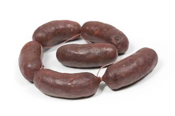 Six crude black pudding sausages on a white background — Stock Photo, Image
