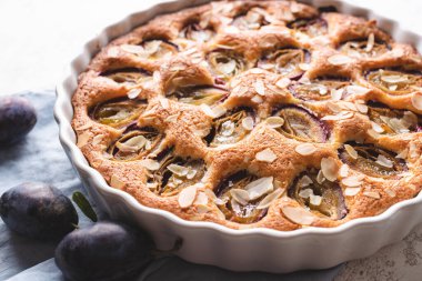 Closeup of raditional American plum torte on white table.
