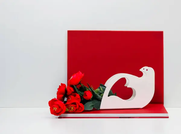 Graceful Heart Shape Dove Figurine Red Flowers Red Book Background — Stock Photo, Image