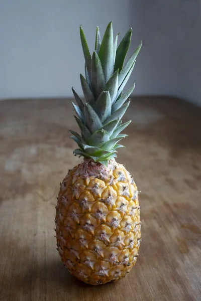 A tropical and delicious pineapple with wood background
