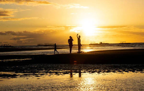 A couple in the beach with the sunset sunrise, silhouette