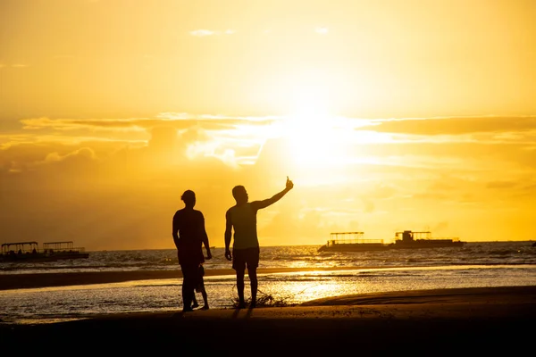 A couple in the beach with the sunset sunrise, silhouette