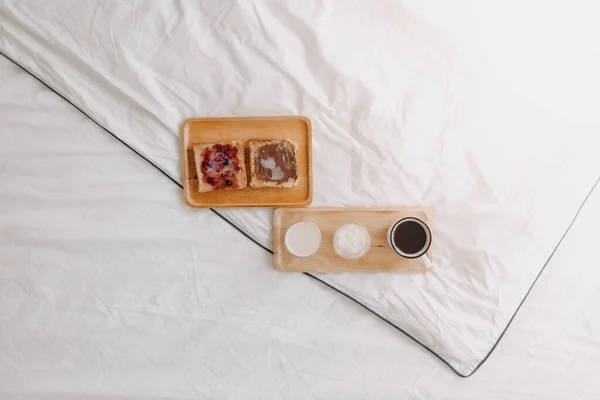 Breakfast set of breads and jam with milk and coffee on white bed. — Stock Photo, Image