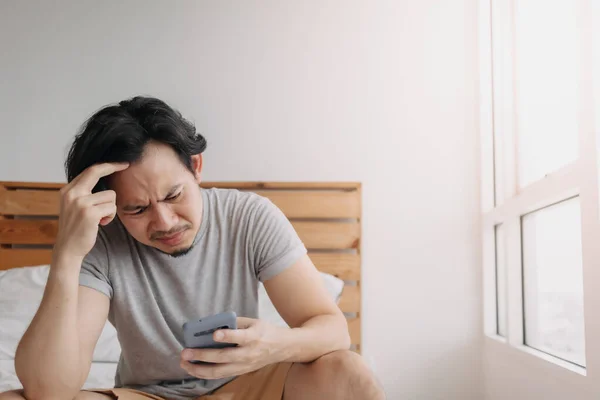 Sad man has bad online chat news and feels disappointed on the smartphone. — Stock Photo, Image