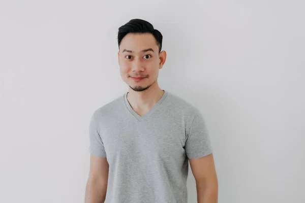 Portrait of Happy man wear grey t-shirt stand isolated on white wall. — Stock Photo, Image