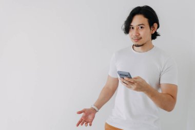 Beyaz arkaplanda akıllı telefon kullanan ve boşluğu kopyalayan mutlu adam.