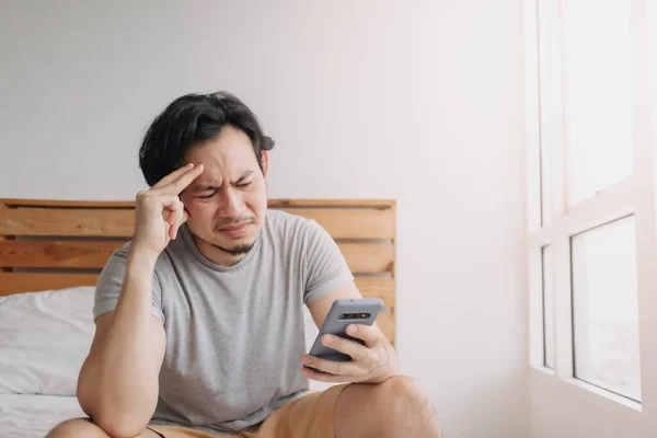 Sad man has bad online chat news and feels disappointed on the smartphone. — Stock Photo, Image