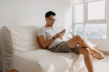 Uzun görüşlü orta yaşlı bir adam. Akıllı telefona bakmaya çalış..