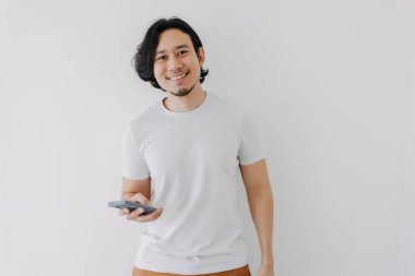 Beyaz arkaplanda akıllı telefon kullanan ve boşluğu kopyalayan mutlu adam.