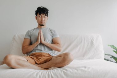 Adam kanepede biraz dikkat dağıtarak meditasyon yapıyor..
