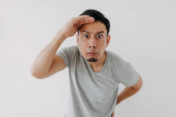 Hombre curioso y obvio en camiseta gris aislado sobre fondo blanco. — Foto de Stock