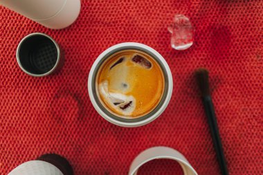 Americano coffee with grinder and handmade equipments on red cloth.