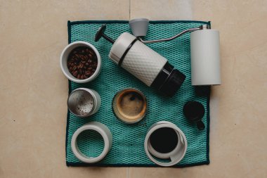 Portatif Fransız presi seti ve yeşil kumaş üzerinde öğütücü kahve ekipmanları..
