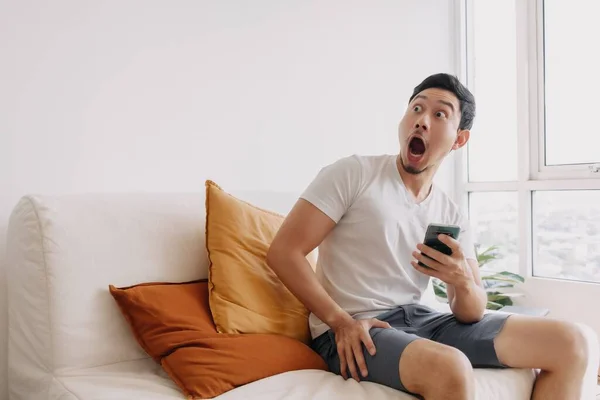 Shocked Surprised Asian Man Using Smartphone Looking Empty Space — Stok fotoğraf