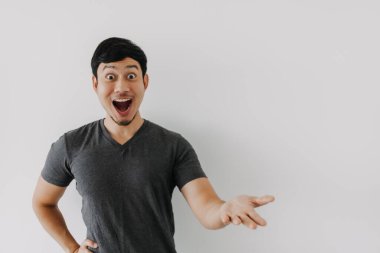 Wow surprise shock face Asian man in black t-shirt isolated on white background.
