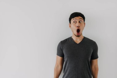 Funny amazing shocked surprised asian man face advertise isolated on white