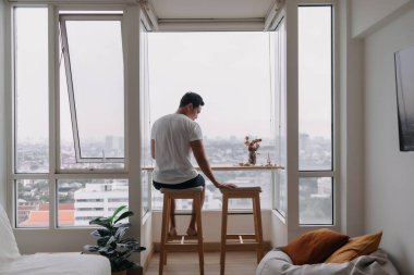 Lonely asian man sit by windows in the room. Concept lonely single broken heart.