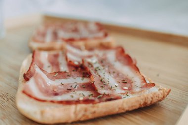 Easy and simple breakfast set of Bacon Sandwich served with black coffee on bed.