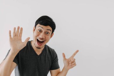 Wow surprise shock face Asian man in black t-shirt isolated on white background.