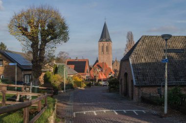Sonbaharda çiftlikleri, kilisesi, evleri ve ağaçları olan Zeddam köyünün boş bir caddesinde manzara