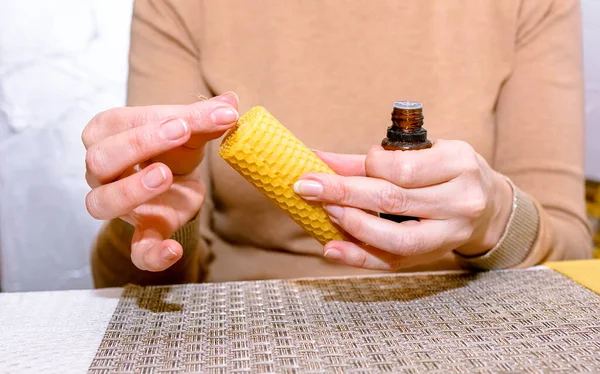 Making a candle from a plate of beeswax. DIY wax candle making process. Step-by-step instruction. Step 3. Wetting the wick with wax