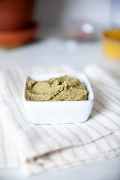 Green dip in a small container on a linen