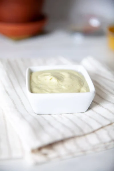 Green dip in a small container on a linen