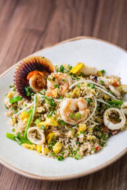 Balık şöförü. Deniz ürünleri ve pirinç tavayı, Çin sebzelerini ve demirhindi sosunu bizim tarzımızda karıştırır..