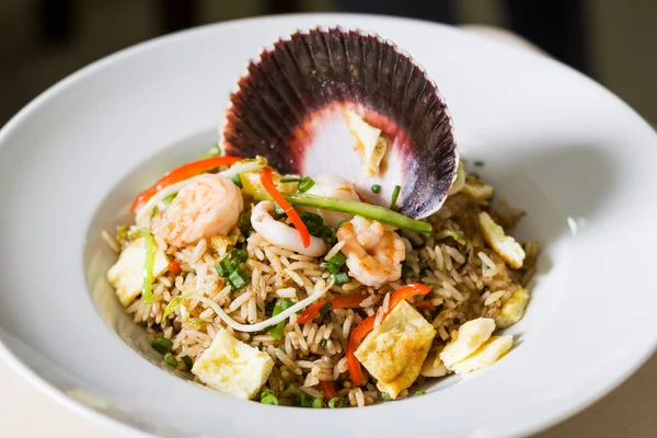 Fish chaufa. Seafood and rice stir up the wok, Chinese vegetables, and tamarind sauce in our style.