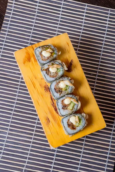 TNT MAKI, Stuffed with shrimp, avocado with a sheet of fan shells.