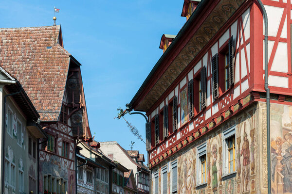 Historical tenement house (apartment building) with facade paintings and half timbered walls in an old town in Swiss city Stein am Rhein in Switzerland
