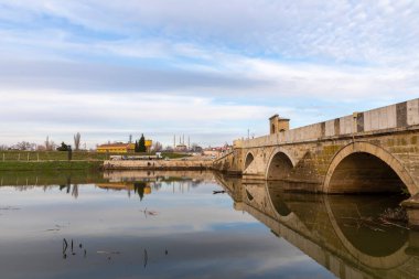 EDIRNE, TURKEY, DECEMBER 22, 2021:Tunca bridge over Tunca river and Selimiye Mosque inEdirne