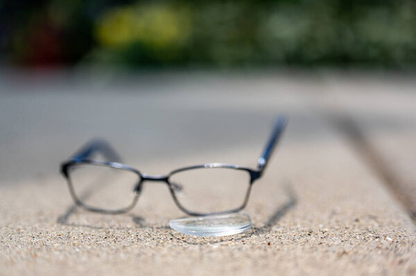 Selective focus on damaged glasses with scratched lens popped out