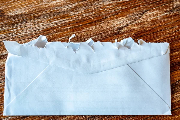 Selective focus on jagged edges of a ripped open mail envelope — Stock Photo, Image