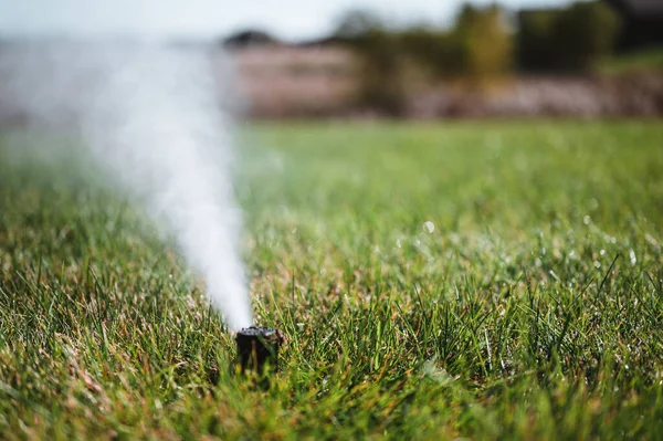 Winterizing a irrigation sprinkler system by blowing pressurized air through to clear out water — Stock Photo, Image
