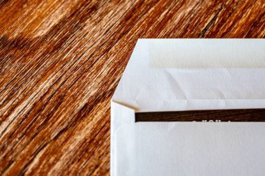 Boş zarf mühürlenmeye ve postayla gönderilmeye hazır. Koyu renkli kağıt kenarı görünür.