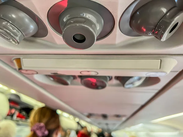 Selective focus on the air vent inside a commercial airplane general seating area. — ストック写真