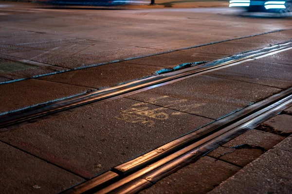 Street level selective focus on trolley rail lines at night in San Diego. High quality photo