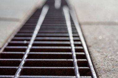 Grate over a stormwater trench in a concrete slab. . High quality photo clipart