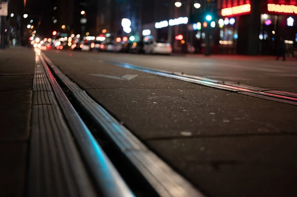 Street level selective focus on trolley rail lines at night in San Diego. High quality photo