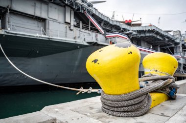 Selective focus on line securing a naval boat to a port bollard. High quality photo
