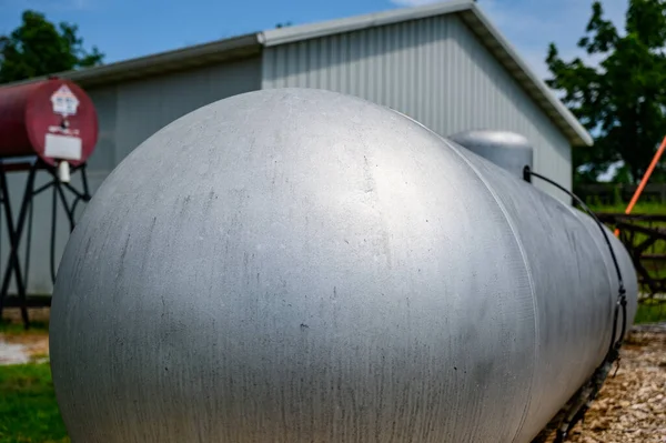 Silver painted liquid propane tank on rural property. High quality photo