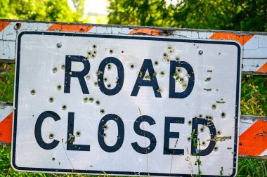 Buckshot road closed sign in front of a washed out bridge. High quality photo