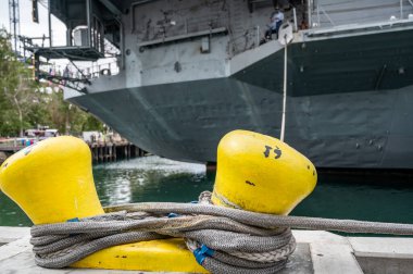 Selective focus on line securing a naval boat to a port bollard. High quality photo