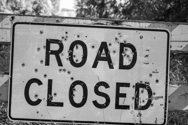 Buckshot road closed sign in front of a washed out bridge. High quality photo