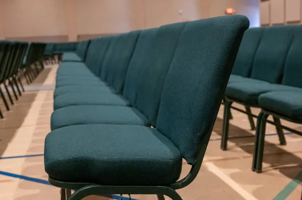 selective focus on a padded seat cushion of a row of chairs in a auditorium. . High quality photo